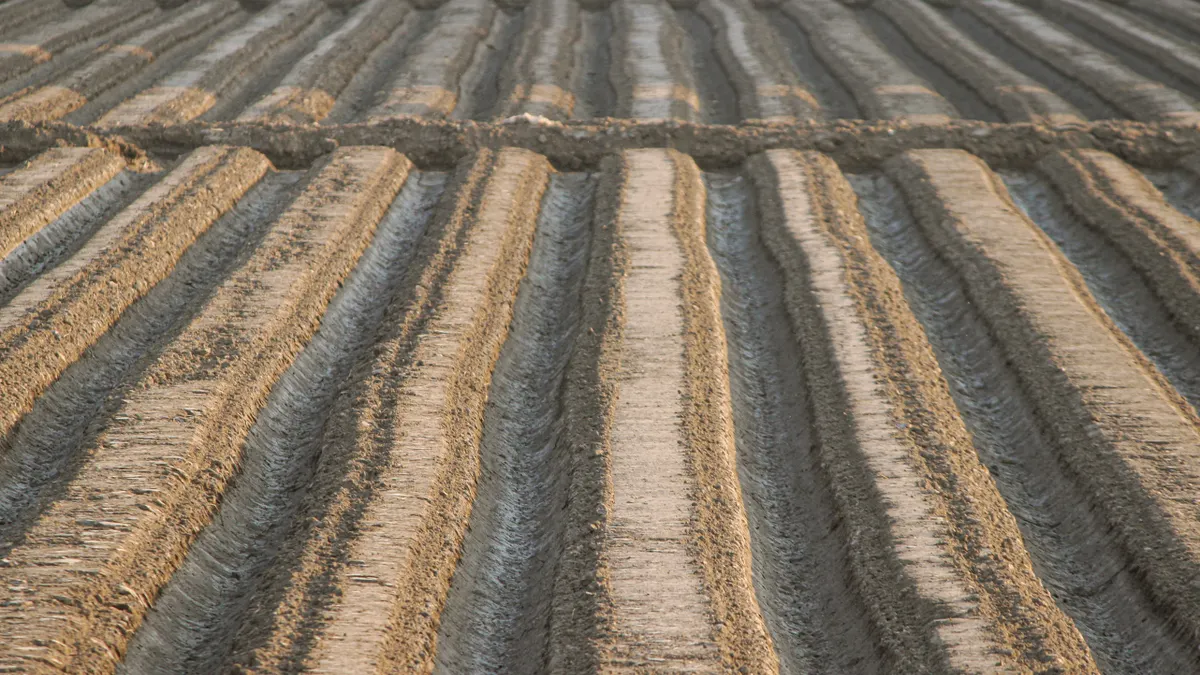 Close view of a furrowed field with soil ridges